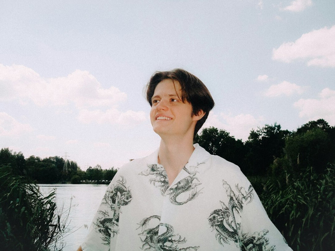 Portrait of a smiling man with short dark hair in a casual shirt