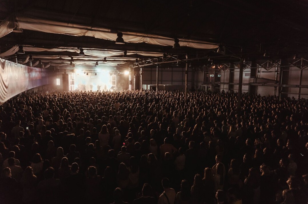 Large conference stage with lighting and screens